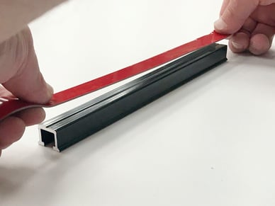 applying structural bonding tape to sign channel